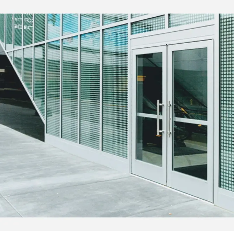 Commercial aluminum entry doors next to a glass block wall
